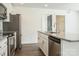 Well-equipped kitchen with a stainless steel dishwasher, island sink, and plenty of counter space at 5962 Charlie Walker Rd, Kannapolis, NC 28081