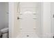 Walk-in shower featuring built-in shelves and modern fixtures at 5962 Charlie Walker Rd, Kannapolis, NC 28081