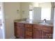 Bathroom with a double sink vanity, granite countertop, and wood cabinetry at 7283 Bradberry Ln, Denver, NC 28037