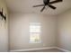 Neutral bedroom featuring a ceiling fan, a window, and carpet floors at 7283 Bradberry Ln, Denver, NC 28037