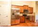 Bright kitchen featuring wooden cabinets, stainless steel appliances, and wood floors at 7283 Bradberry Ln, Denver, NC 28037
