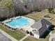 Aerial view showcasing a community pool, lounge chairs, and playground, ideal for leisure and recreation at 7283 Bradberry Ln, Denver, NC 28037