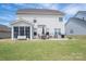 Spacious backyard with patio, grill, seating, and green grass at 7924 Creek Park Dr, Denver, NC 28037