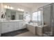 Spacious bathroom featuring double vanity, soaking tub and glass shower enclosure at 7924 Creek Park Dr, Denver, NC 28037