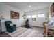 Bright exercise room with stationary bike, cozy blue chair, desk, and decorative shelves at 7924 Creek Park Dr, Denver, NC 28037