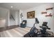 Inviting exercise area featuring sleek stationary bike, cozy blue chair, and stylish decor at 7924 Creek Park Dr, Denver, NC 28037