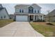 Charming two-story home with stone accents, covered porch, well-kept lawn, and a spacious driveway at 7924 Creek Park Dr, Denver, NC 28037