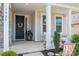 Warm and welcoming front entrance with decorative wreath, charming statues, and elegant architectural details at 7924 Creek Park Dr, Denver, NC 28037