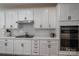 Stylish kitchen with white cabinets, stainless steel appliances, and a gas cooktop for gourmet cooking at 7924 Creek Park Dr, Denver, NC 28037