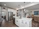 Modern kitchen with stainless steel appliances, white cabinets, and a functional island with bar seating at 7924 Creek Park Dr, Denver, NC 28037