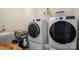 Convenient laundry room with modern washer and dryer units, utility sink, and ample shelving for storage at 7924 Creek Park Dr, Denver, NC 28037