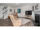 Relaxing living room featuring a fireplace, comfortable recliners, and stylish decor for a cozy atmosphere at 7924 Creek Park Dr, Denver, NC 28037