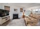 Cozy living room with a fireplace, plush seating, and access to the dining area, great for entertaining at 7924 Creek Park Dr, Denver, NC 28037