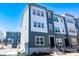Contemporary townhome with blue and gray facade, modern windows, and low-maintenance landscaping at 8010 Elevate Ct, Charlotte, NC 28205