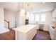 Modern kitchen with white cabinetry, stainless steel appliances, and large center island featuring pendant lighting at 8010 Elevate Ct, Charlotte, NC 28205