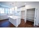 Spacious kitchen with a large island, open pantry, and modern pendant lighting at 8010 Elevate Ct, Charlotte, NC 28205