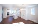 Open kitchen featuring white cabinets, stainless steel appliances, island with pendant lighting, and hardwood floors at 8010 Elevate Ct, Charlotte, NC 28205
