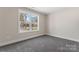 A bright bedroom with a large window offers views of the neighborhood and ample natural light at 816 S Confederate Ave, Rock Hill, SC 29730