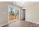 Bright bedroom with sliding glass door leading to deck, complemented by wood-style flooring at 816 S Confederate Ave, Rock Hill, SC 29730