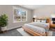 A bedroom with a large window, natural light, and a neutral color scheme creates a serene atmosphere at 816 S Confederate Ave, Rock Hill, SC 29730