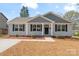Charming home features a manicured lawn, complemented by dark shutters and light gray siding at 816 S Confederate Ave, Rock Hill, SC 29730