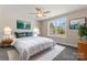 Sunlit main bedroom showcasing a plush bed, window view, and stylish contemporary decor at 816 S Confederate Ave, Rock Hill, SC 29730
