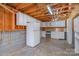 Unfinished basement area with white cabinets, open ceiling, and concrete floors, offering potential for customization at 820 N Main St, Salisbury, NC 28144