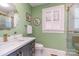 Stylish bathroom with green walls, a marble vanity, and modern gold fixtures at 820 N Main St, Salisbury, NC 28144