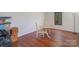 Cozy dining area featuring wood floors and a round table with two chairs next to a window at 820 N Main St, Salisbury, NC 28144