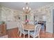 Inviting dining room with floral wallpaper, chandelier, and a wooden table with seating for six at 820 N Main St, Salisbury, NC 28144