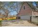 Exterior view of a charming home with a two-car garage, gravel driveway, and fenced yard at 820 N Main St, Salisbury, NC 28144