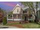 Stunning two-story home with a covered front porch, showcasing classic architecture and a well-manicured lawn at 820 N Main St, Salisbury, NC 28144