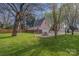 Garage and well-maintained backyard with mature trees, and lawn at 820 N Main St, Salisbury, NC 28144