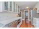Well-equipped kitchen with glass-front cabinets, stainless steel appliances, and hardwood floors at 820 N Main St, Salisbury, NC 28144