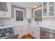 Modern kitchen featuring white cabinets, a farmhouse sink, and stainless steel appliances at 820 N Main St, Salisbury, NC 28144
