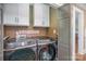 Well-organized laundry room featuring a modern Samsung washer and dryer, and built-in storage cabinets at 820 N Main St, Salisbury, NC 28144