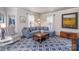 Cozy living room with comfortable seating, a patterned rug, and natural light from surrounding windows at 820 N Main St, Salisbury, NC 28144