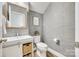 Stylish half-bath features a modern vanity, decorative mirror, and textured wallpaper at 822 Flatwater Ct, Fort Mill, SC 29708