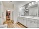 Well-lit bathroom featuring double sinks, modern fixtures, and a gray textured wall at 822 Flatwater Ct, Fort Mill, SC 29708