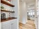 Charming butler's pantry with floating shelves, coffee station, and marble backsplash at 822 Flatwater Ct, Fort Mill, SC 29708