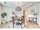Cozy dining room with stylish light fixture, decor, and hardwood floors at 822 Flatwater Ct, Fort Mill, SC 29708