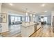 Open-concept kitchen boasts a large island, stainless steel appliances, and seamless flow into the living and dining areas at 822 Flatwater Ct, Fort Mill, SC 29708