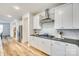 Modern kitchen features white cabinets, stainless steel appliances, gas range, and stylish backsplash at 822 Flatwater Ct, Fort Mill, SC 29708