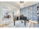Open-concept living room with piano, chandelier, and adjacent dining area at 822 Flatwater Ct, Fort Mill, SC 29708