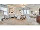 Bright main bedroom with neutral carpeting, tray ceilings, and luxurious decor in natural light at 822 Flatwater Ct, Fort Mill, SC 29708