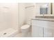 Bright bathroom features granite countertop, new sink, a walk-in shower with glass doors at 8432 Strider Dr, Charlotte, NC 28212