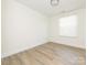 Clean bedroom featuring hardwood floors and a large window, bright and airy at 8432 Strider Dr, Charlotte, NC 28212