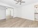 Bright bedroom features modern flooring, a ceiling fan, neutral walls, and mirrored closet doors at 8432 Strider Dr, Charlotte, NC 28212
