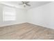 Bright bedroom features modern flooring, a ceiling fan, neutral walls, and ample natural light at 8432 Strider Dr, Charlotte, NC 28212