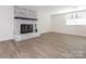 Spacious living room featuring hardwood floors, a fireplace, and a modern chandelier at 8432 Strider Dr, Charlotte, NC 28212